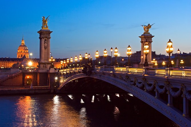 Paris Private Night Tour with River Cruise and Champagne Option - The Louvre pyramid after sunset
